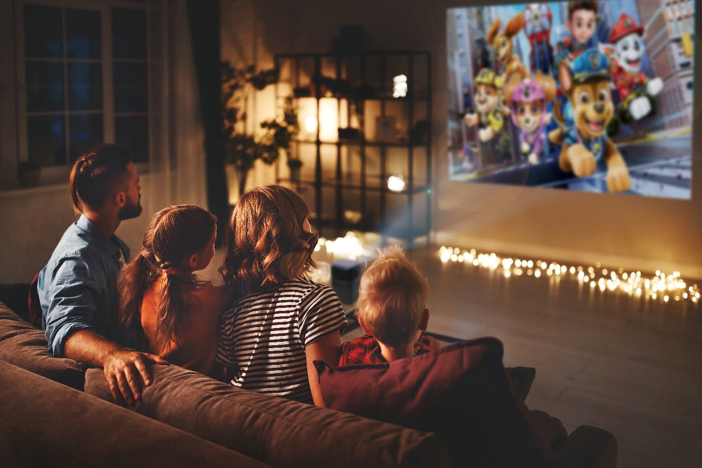 group of people sitting on a couch watching a television as one of Kid Activities to do at Home