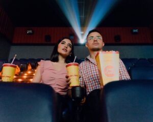 man and woman watching a movie