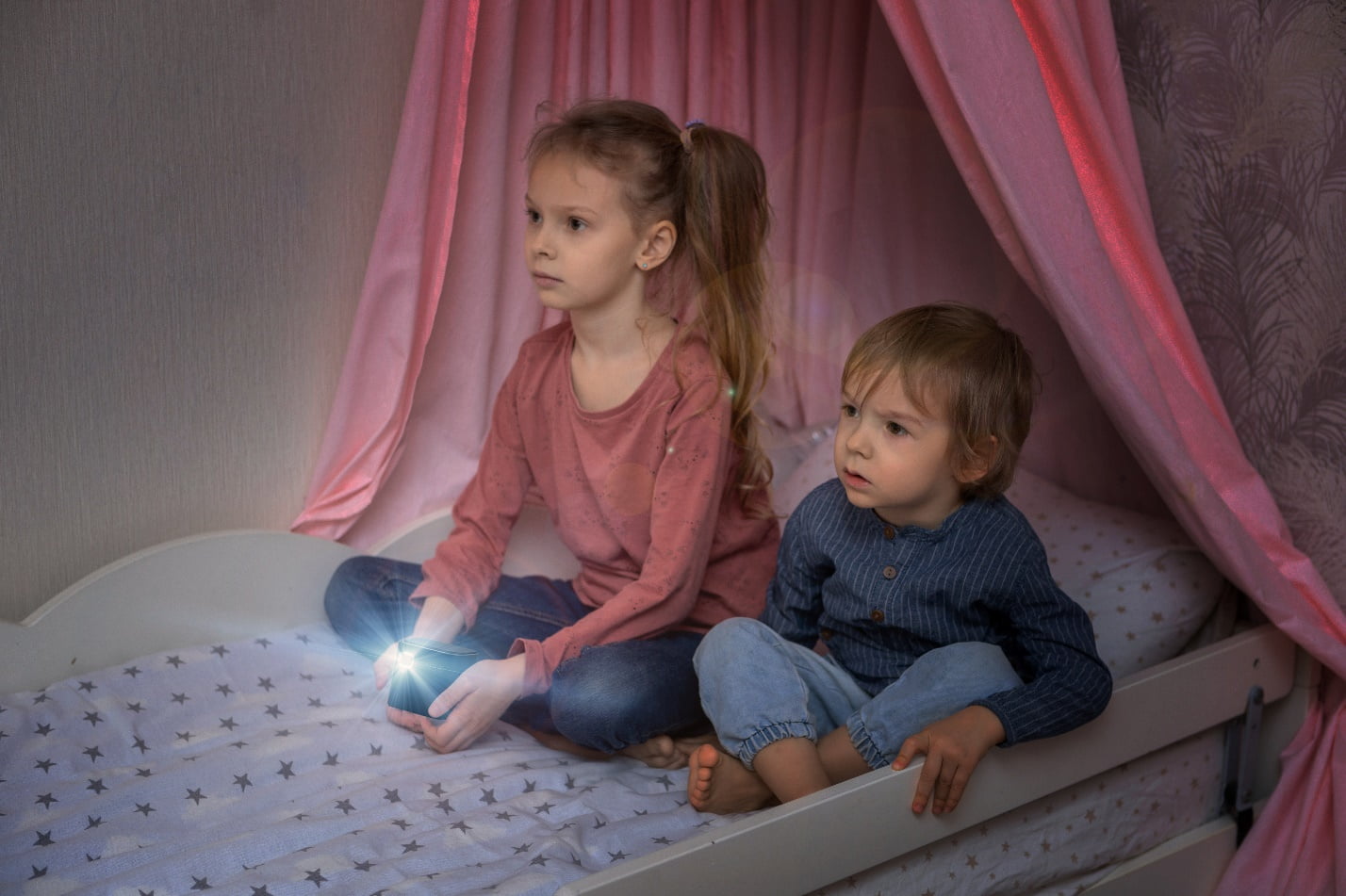 two children watching movies using portable mini projector