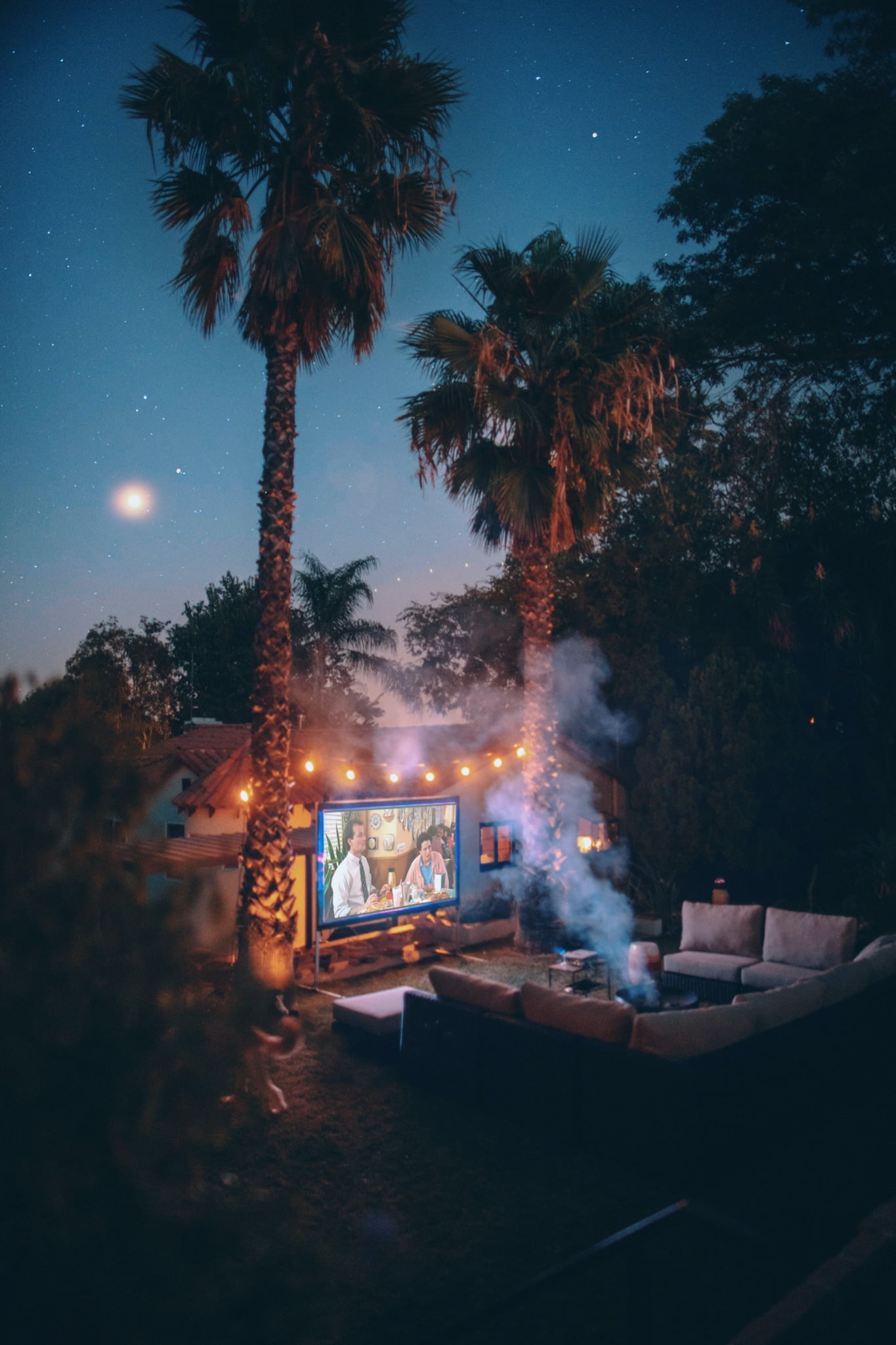 Summer movie night at home backyard using portable projector